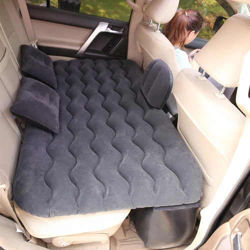 Black inflatable air mattress in a car back seat