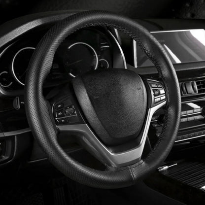 Hand-stitched black steering wheel cover installed in a car