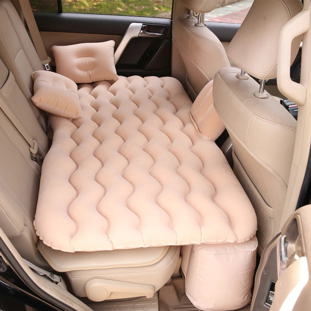 Beige air mattress with pillows in a car back seat
