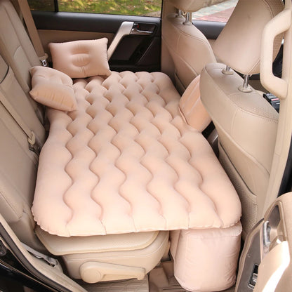 Beige air mattress with pillows in a car back seat