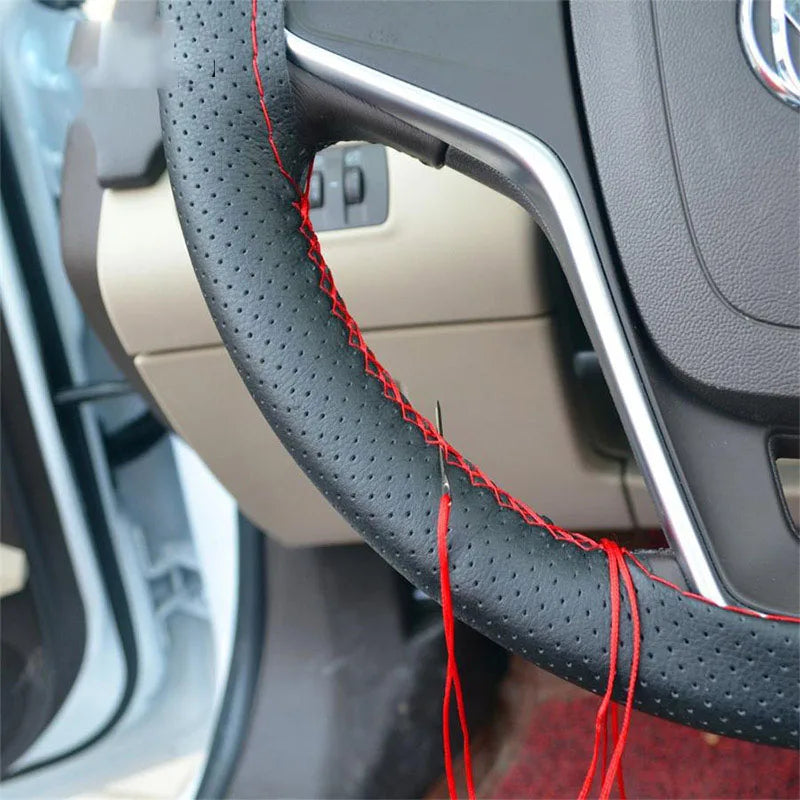 Installed steering wheel cover with red stitching