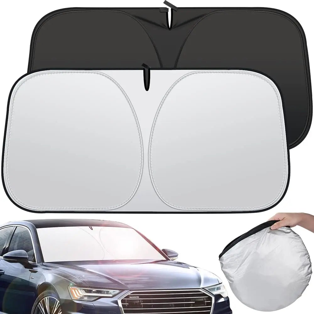 Twist-fold windshield sun shade, silver outer side and black inner side, shown in a car and folded