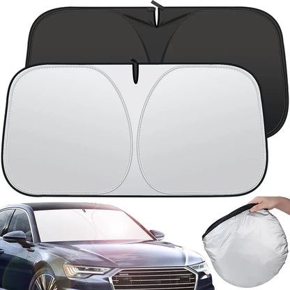 Twist-fold windshield sun shade, silver outer side and black inner side, shown in a car and folded