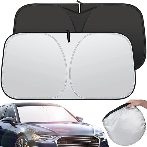Twist-fold windshield sun shade, silver outer side and black inner side, shown in a car and folded