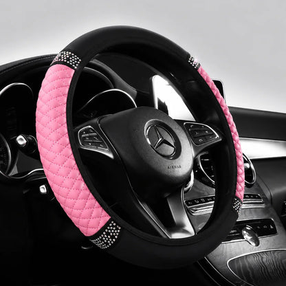 Pink perforated leather steering wheel cover on a steering wheel
