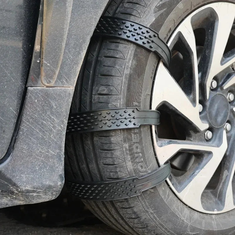 Black snow chain strap on a car tire