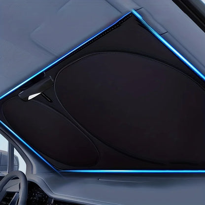 Twist-fold sun shade in a windshield, seen from inside the car