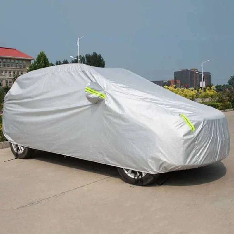 Two-tone silver car cover on an SUV parked outdoors