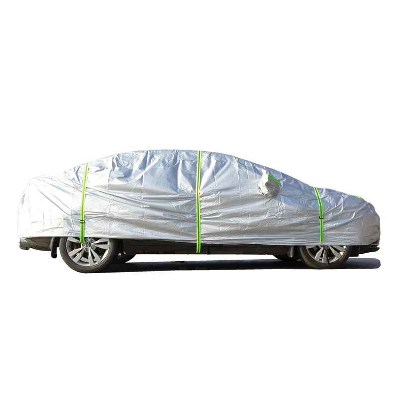 Silver car cover on a sedan, side view