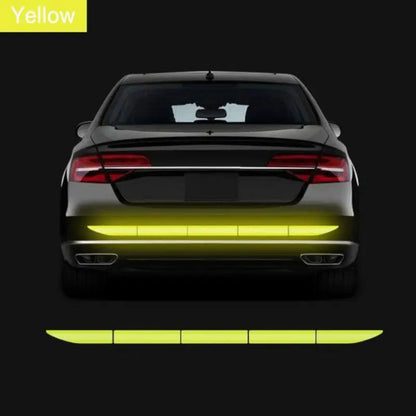 Green reflective strip on the rear bumper of a car