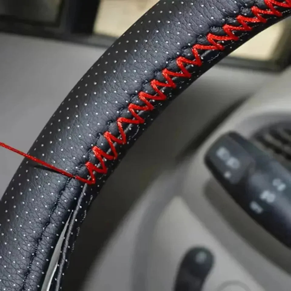 Close-up of red stitching on the steering wheel cover