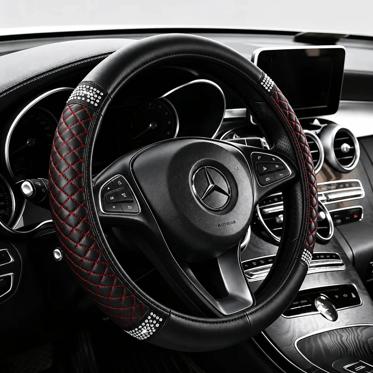 Black perforated leather steering wheel cover on a car steering wheel