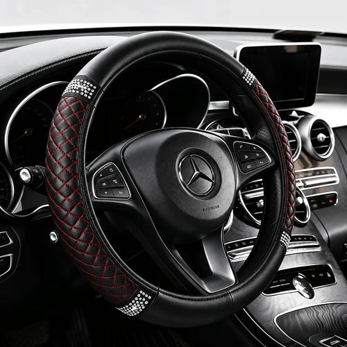 Black perforated leather steering wheel cover on a car steering wheel