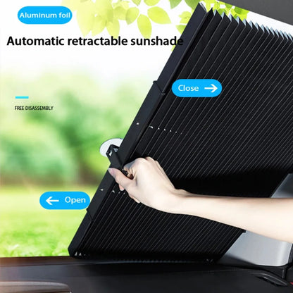 Pulling the retractable sun shade across the windshield