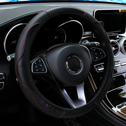 Black carbon fiber pattern steering wheel cover on a car steering wheel