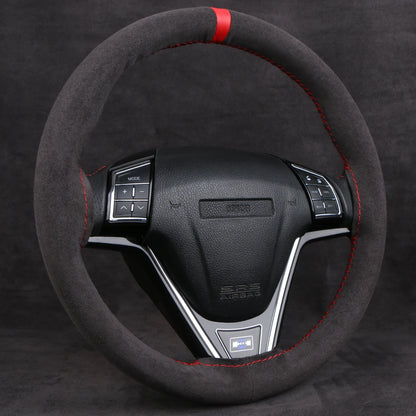 Black faux suede steering wheel cover with a red center stripe on a steering wheel