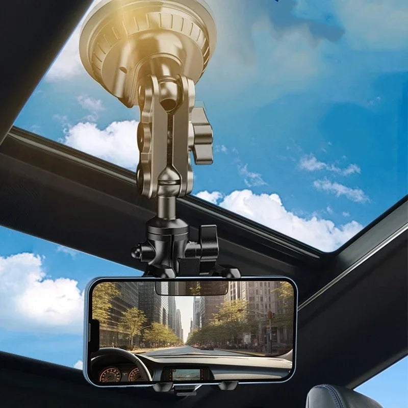 Suction cup phone mount holding a phone against a car sunroof