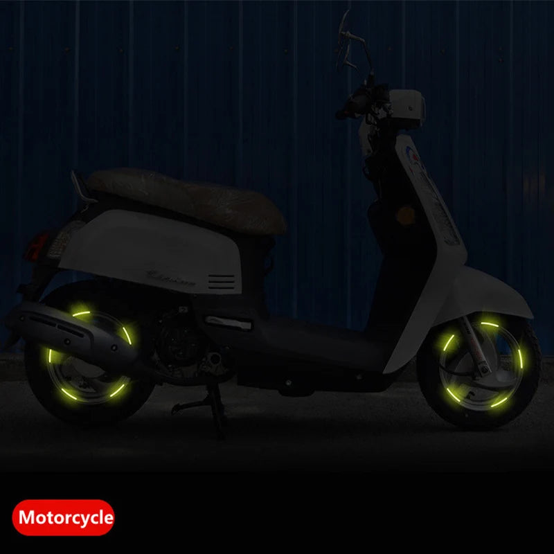 Reflective rim strips on a scooter wheel at night