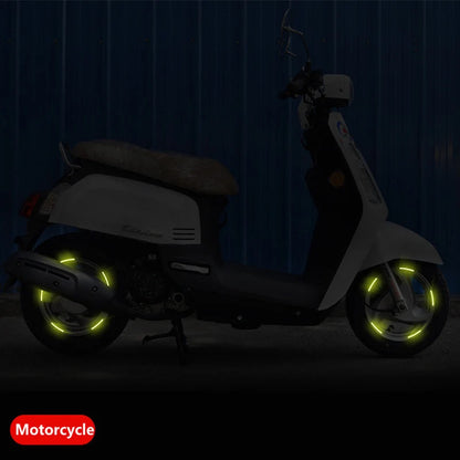 Reflective rim strips on a scooter wheel at night