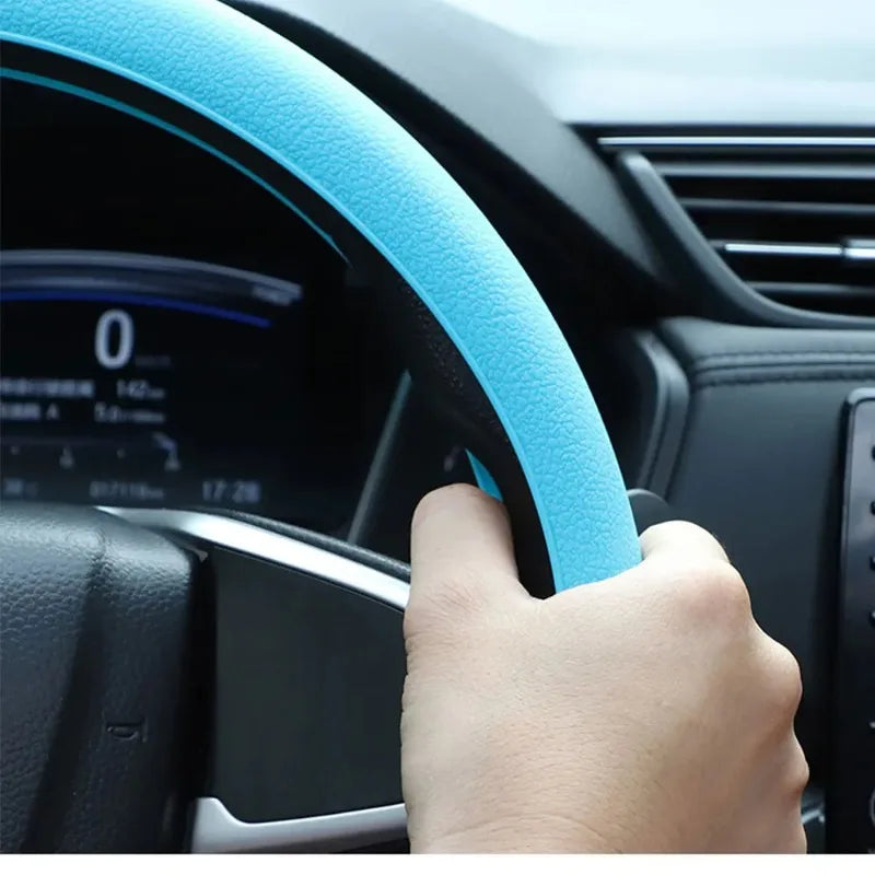 Driver's hand on a silicone steering wheel cover